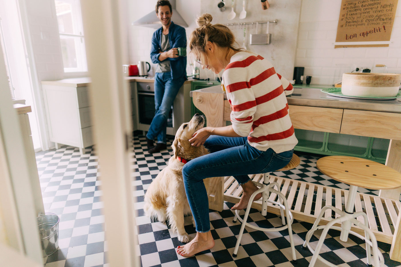 Couple in the kitchen with their dog