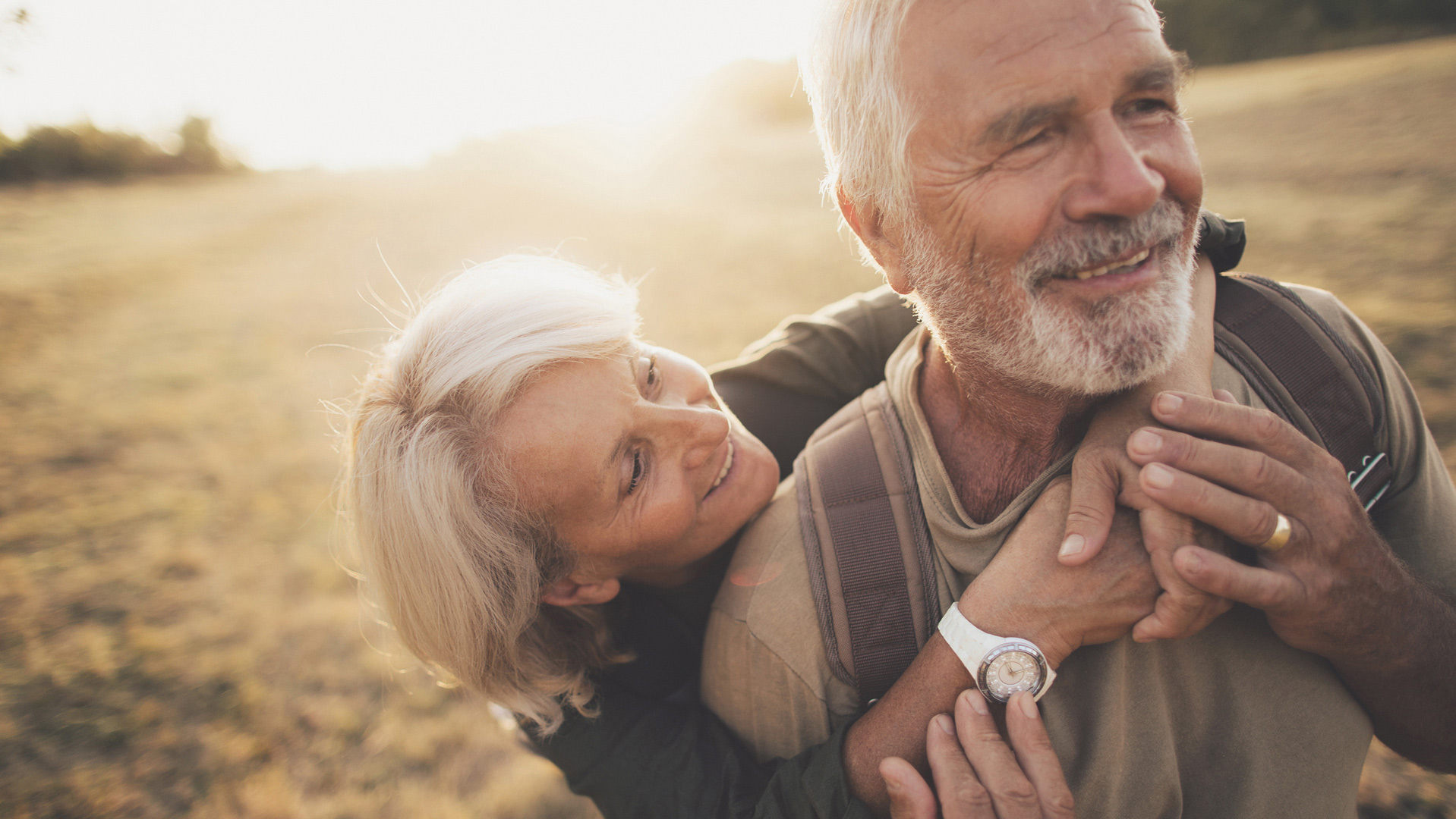 Couple  on field holding each other